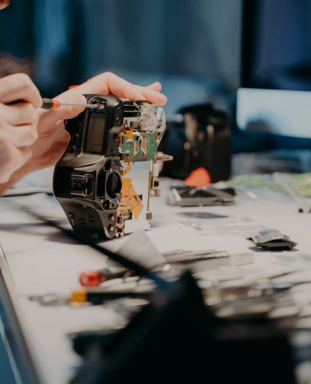 unknown-man-repairs-professional-digital-camera-u-2021-10-21-03-37-54-utc